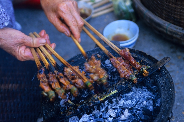 Woman Cooking Kebabs, Hoi An, Vietnam